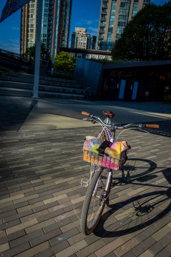 A Velo orange bicycle is on a kickstand in the morning at a playground for coffee outside