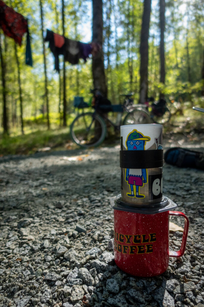 A camp cup that says Bicycle Coffee has an Aeropress on top of it.